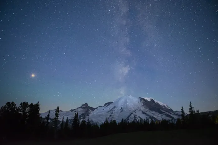 Framed Print : The lights of climbers can be seen on the mountain as the Milky Way rises behind Mt