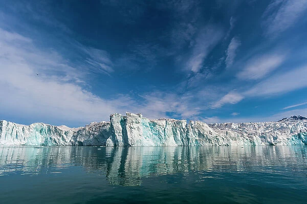 Lilliehook Glacier and its mirror reflection on arctic waters. Lilliehookfjorden, Spitsbergen Island, Svalbard, Norway
