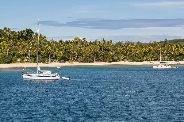 Little sailing boat in the blue lagoon, Yasawas, Fiji, South Pacific