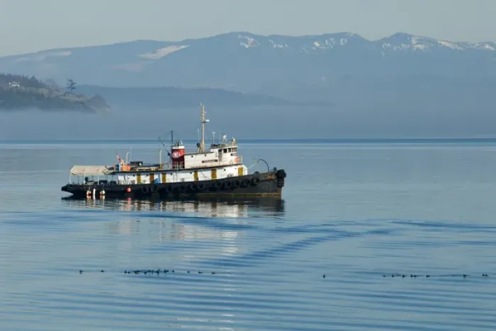 Framed Print : Live-aboard tugboat anchored in Penn Cove with Cascade Mountains beyond