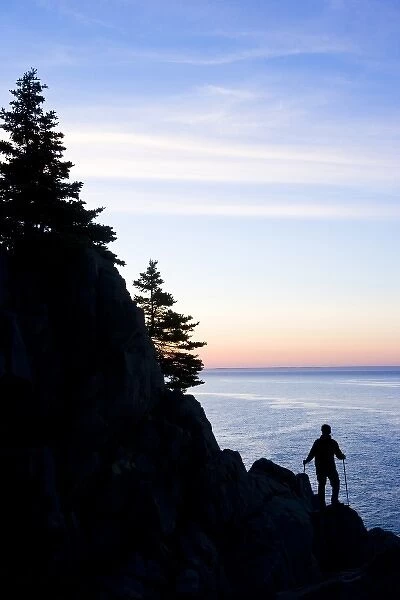 A lone hiker at sunrise on the Bold Coast trail in Cutler, Maine. Cutler Coast Public Reserved Land