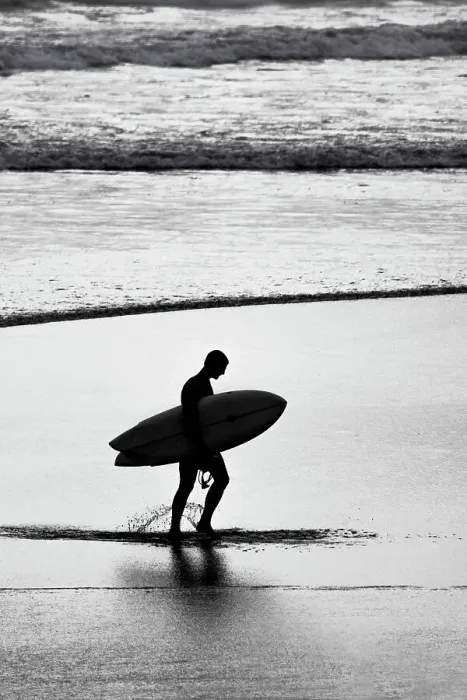 Framed Print : Lone surfer along the beach coming from the surf Framed Print : Lone surfer along the beach coming from the surf