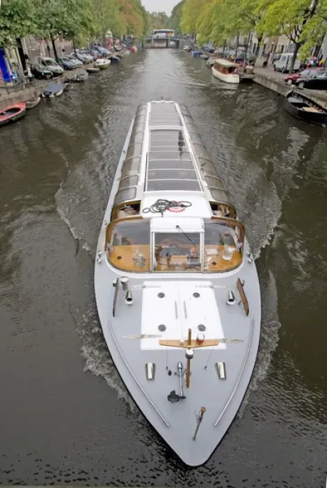 Framed Print : A long glass topped tour boattravels down a boat lined canal Framed Print : A long glass topped tour boattravels down a boat lined canal