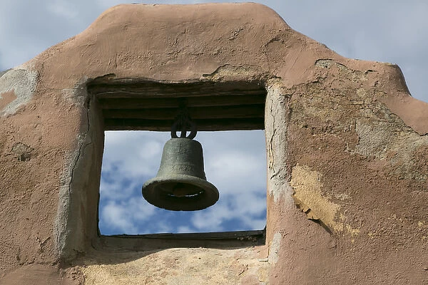 Looking up at a church bell of an adobe building, Taos, New Mexico, USA