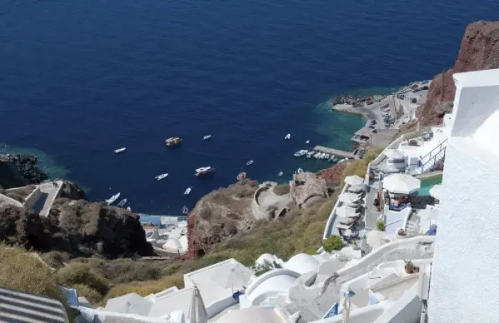 Framed Print : Looking down at fishing village in Oia in Santorini Greece in the Greek Islands Framed Print : Looking down at fishing village in Oia in Santorini Greece in the Greek Islands