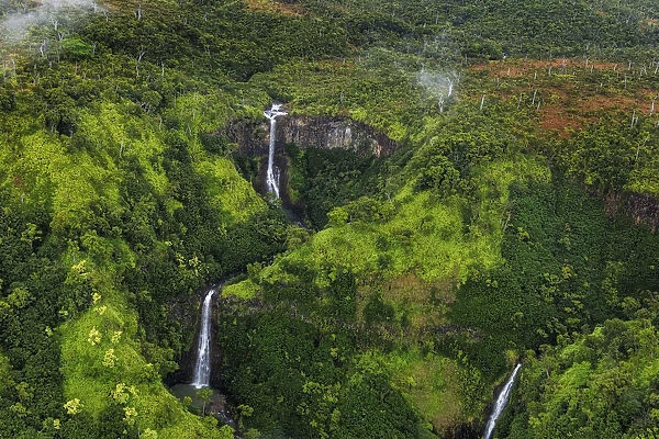 Lush Inland waterfalls during helicopter tour in Kauai, Hawaii, USA