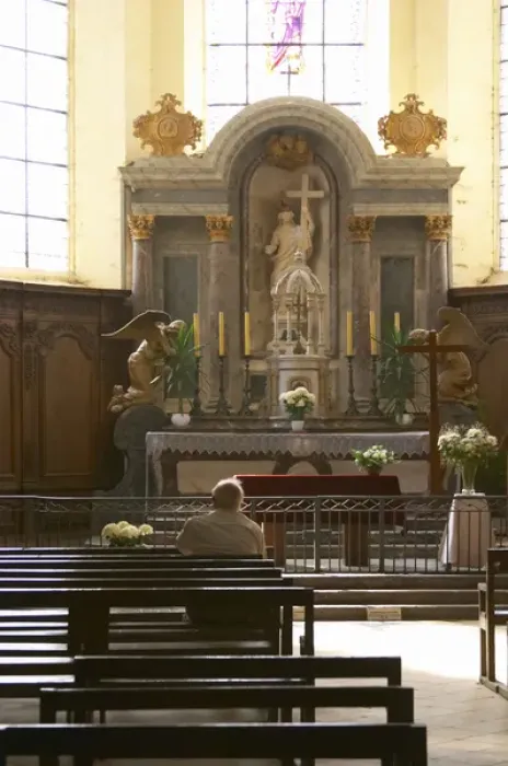 Framed Print : A man contemplating on a bench in a church in front of the altar with a ray of sunshine Framed Print : A man contemplating on a bench in a church in front of the altar with a ray of sunshine