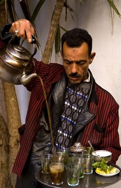Man pouring tea for sale in Medina area of Tunis Tunisia of Northern Africa
