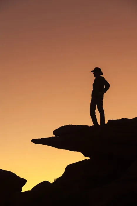 Framed Print : Man standing on rock surveying the view. (MR)