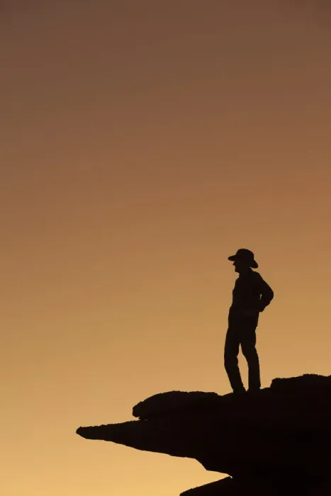 Framed Print : Man standing on rock surveying the view. (MR)