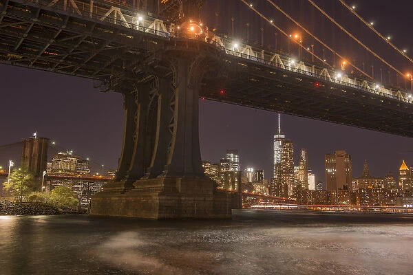 The Manhattan Bridge and Manhattan skyline in the evening light from Brooklyn Bridge Park