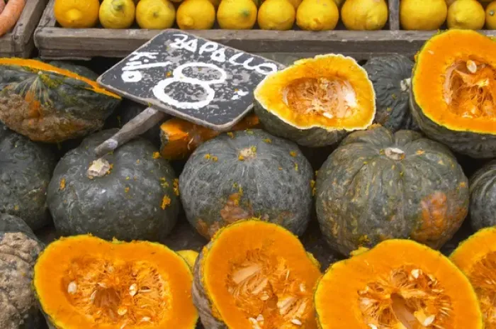 Framed Print : A market stall street market merchant selling pumpkins some cut in half to display