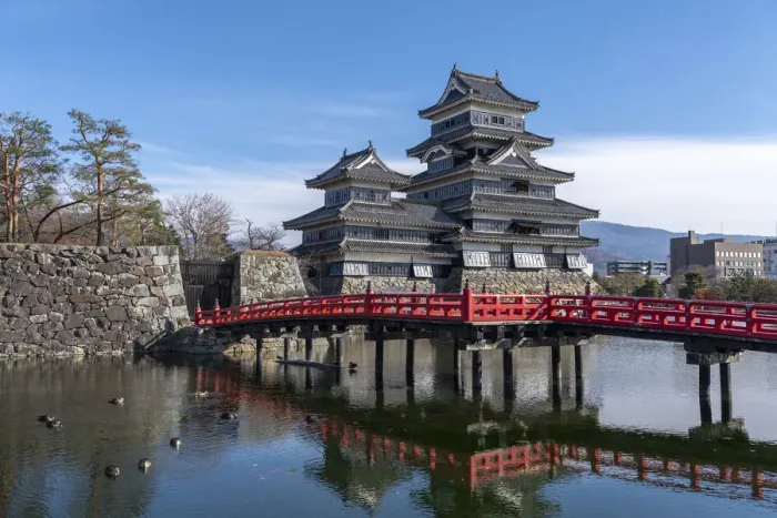 Framed Print : The Matsumoto Castle as seen from the bridge with the city buildings in the background Framed Print : The Matsumoto Castle as seen from the bridge with the city buildings in the background