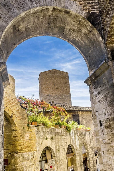 Medieval stone arch and tower, San Gimignano, Tuscany, Italy