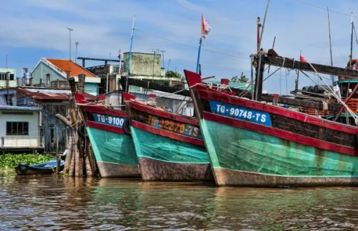 Framed Print : Mekong Delta. A row of fishing boats below Ho Chi Minh City (Saigon), Vietnam