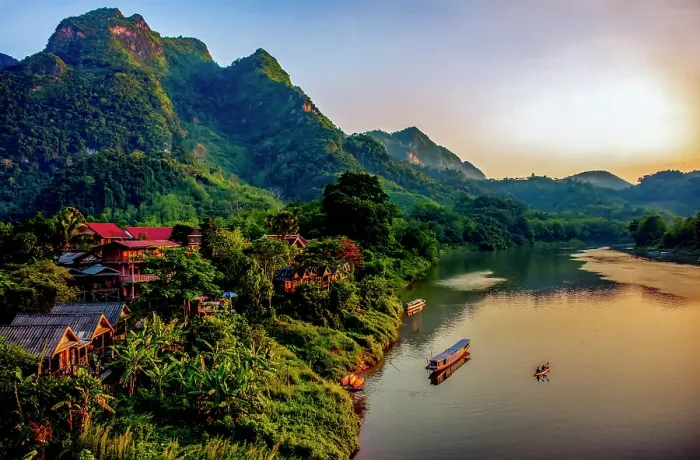 Framed Print : Mekong River village, Laos. Landscape view of mountain village at sunset lighting river and mountains