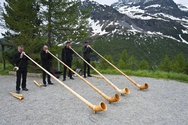 Men playing alpenhorn or alpine horn, Switzerland