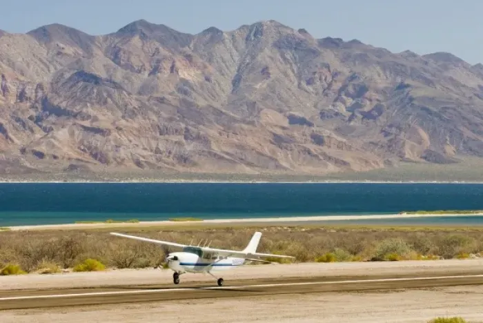 Framed Print : Mexico, Baja California, Bahia de los Angeles. Small aircraft lands with dramatic