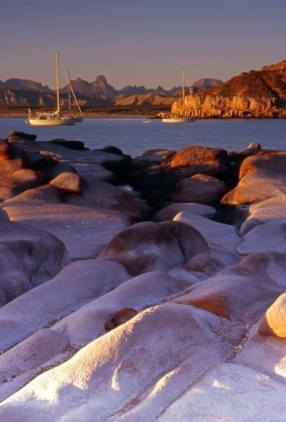 Mexico, Baja Peninsula, Sea of Cortez, Puerto Gato, sailboats at sunrise from sandstone