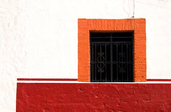 Mexico, Cabo San Lucas. Detail of colorful window with decorative wrought iron bars