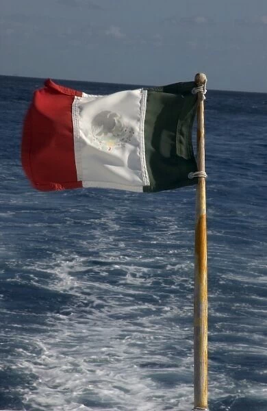 Mexico, Cozumel, dive boat with Mexican flag flying off the stern