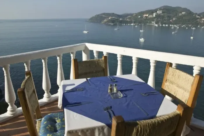 Framed Print : Mexico, Guerrero, Zihuatanejo. Cafe Table over Zihuatanejo Bay