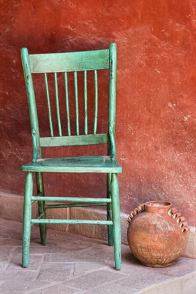 Mexico, San Miguel de Allende. An empty chair and terracotta pot on a colorful porch