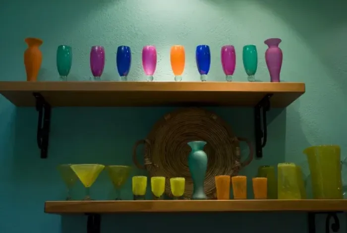 Framed Print : Mexico, San Miguel de Allende. Colorful collection of glassware on two shelves against Framed Print : Mexico, San Miguel de Allende. Colorful collection of glassware on two shelves against