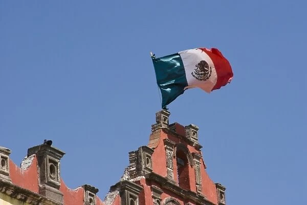 Mexico, San Miguel de Allende. Mexican flag flies in breeze atop Colegio de Sales school