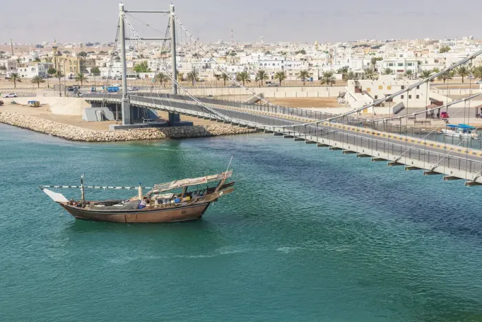 Framed Print : Middle East, Arabian Peninsula, Oman, Al Batinah South. Dhow passing under a suspension