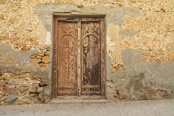 Middle East, Arabian Peninsula, Al Batinah South. Old wooden door on a building in Oman