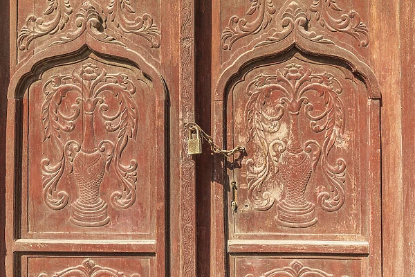 Middle East, Arabian Peninsula, Al Batinah South. Carved wooden door on a building in