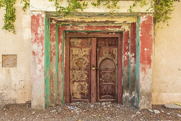 Middle East, Arabian Peninsula, Al Batinah South. Old carved wooden door on a building in