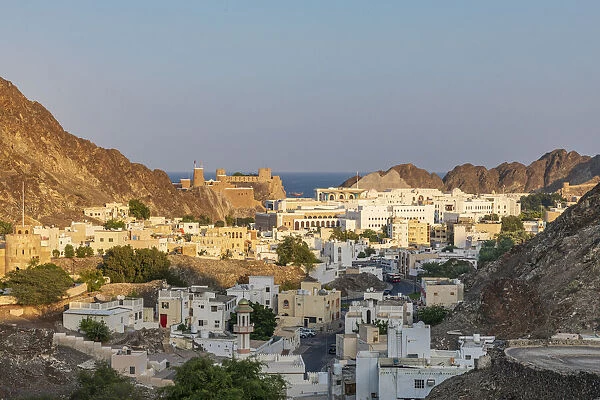 Middle East, Arabian Peninsula, Oman, Muscat. Sunset view of a neighborhood in the hills