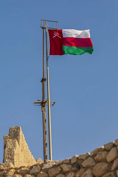 Middle East, Arabian Peninsula, Oman, Muscat, Muttrah. Omani flag flying in Muttrah