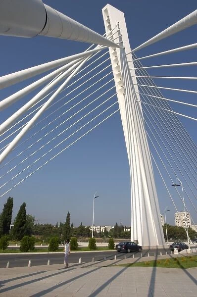 The Millennium Bridge spans Moraca River with cables that form a graphic pattern