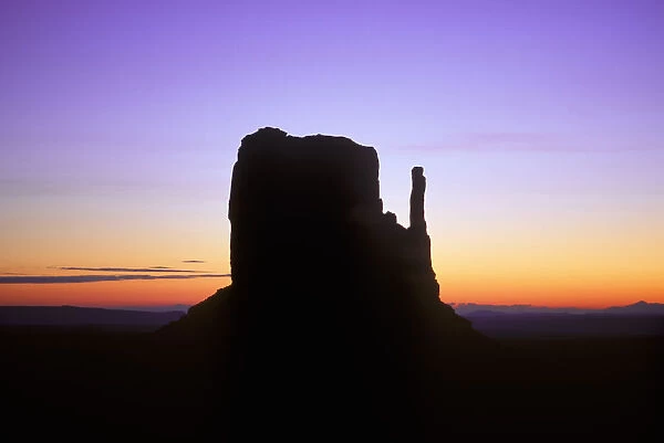 Mitten Butte silhouetted against dawn sky, Monument Valley Navajo Tribal Park, Arizona, USA