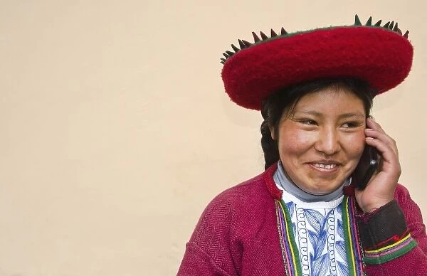 Modern life in Peru woman in traditional dress and hat with cell phone communicating via wireless
