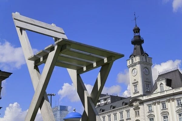 Modern sculpture with historical building, Warsaw, Poland