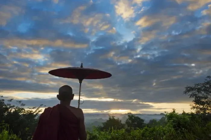 Framed Print : Monk with umbrella watching ancient temple and pagoda in the jungle at sunrise, Mrauk-U