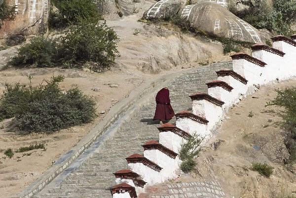 Monk walking the stairs in Drepung Monastery, one of the great three Gelug university