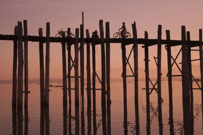 Framed Print : Monk walking at sunrise over the lake near wooden footbridge Framed Print : Monk walking at sunrise over the lake near wooden footbridge