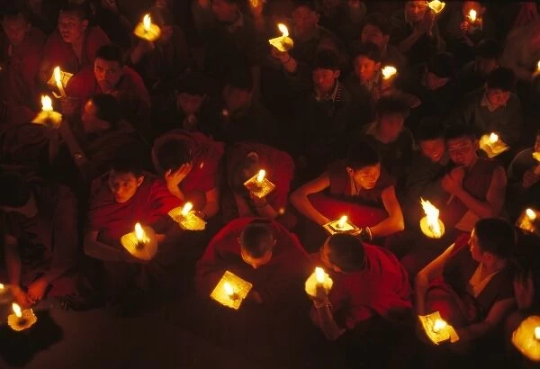 Monks demonstrate a protest with candles
