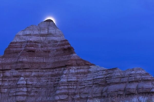 Full moon rises over colorful badlands in the Grand Staircase Escalante National Monument in Utah