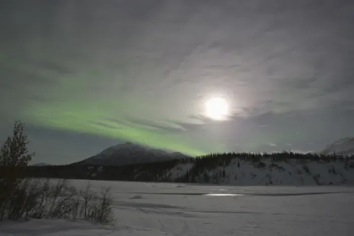 Framed Print : The moon rises over a curtain of green aurora borealis shimmering over the Middle