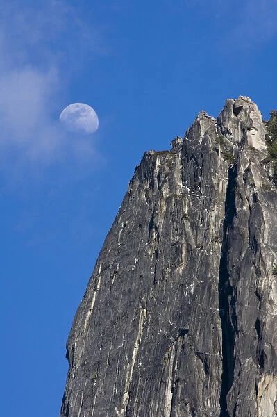 The moon rises and shines through the clouds above Cathedral Rock - Yosemite National Park