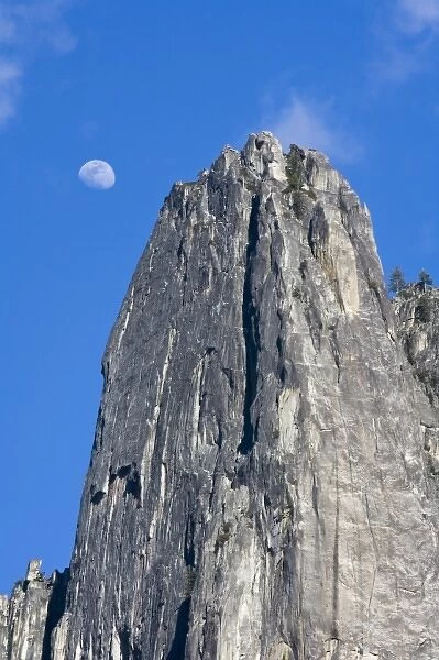 The moon rises and shines through the clouds above Cathedral Rock - Yosemite National Park