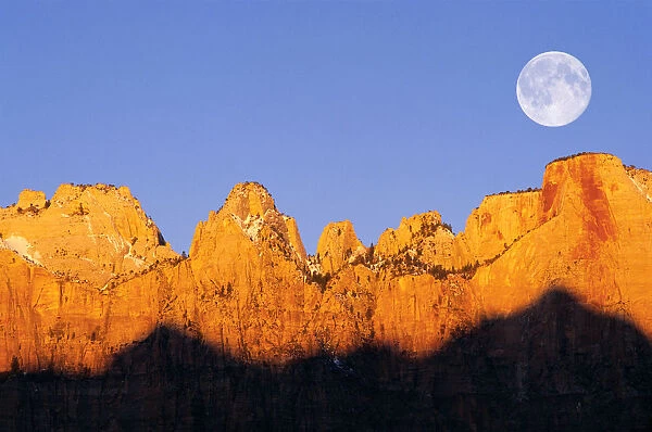 Full moon and winter dawn on the Towers of the Virgin, Zion National Park, Utah, USA