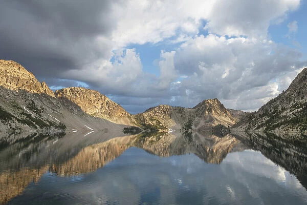 Morning clouds mirrored in still waters of Sawtooth Lake, Sawtooth Mountains Wilderness, Idaho