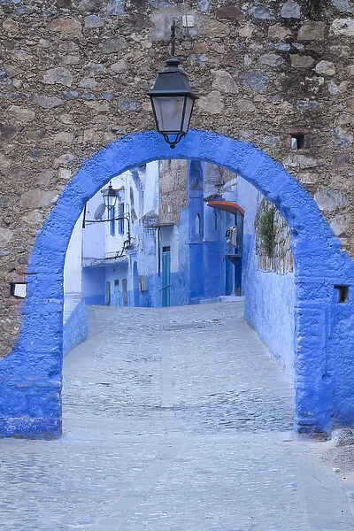 Morocco, Chefchaouen. A blue arch and quiet street entering the medina of the village